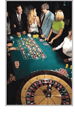 group of people placing bets at the roulette table